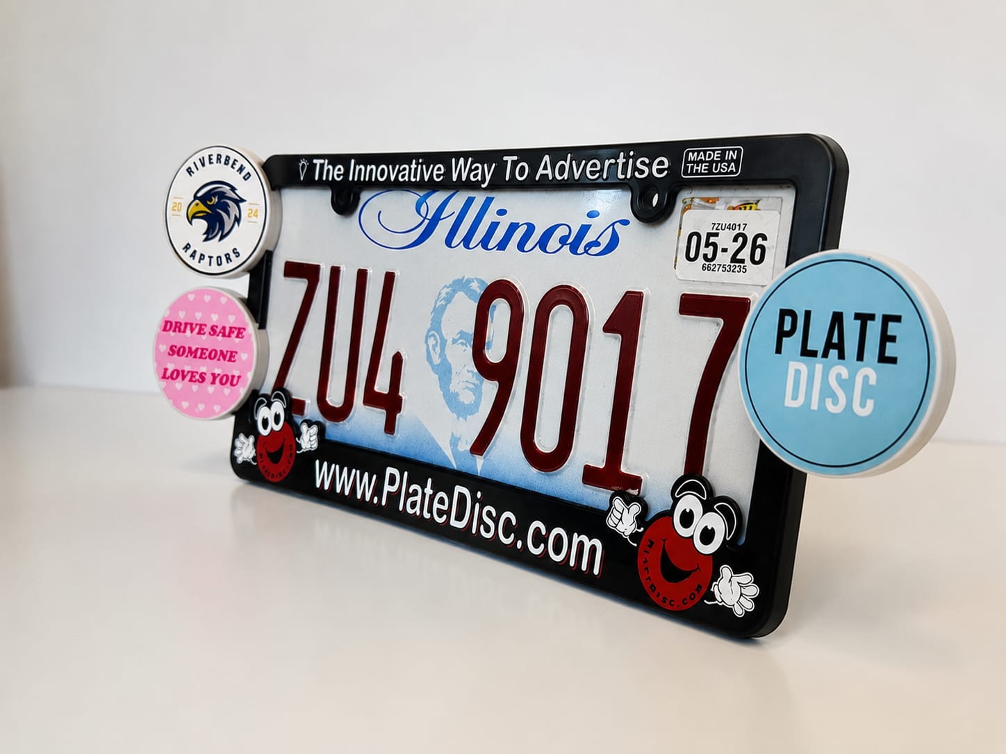 A Plate Disc license plate frame with team discs clipped onto the side rails